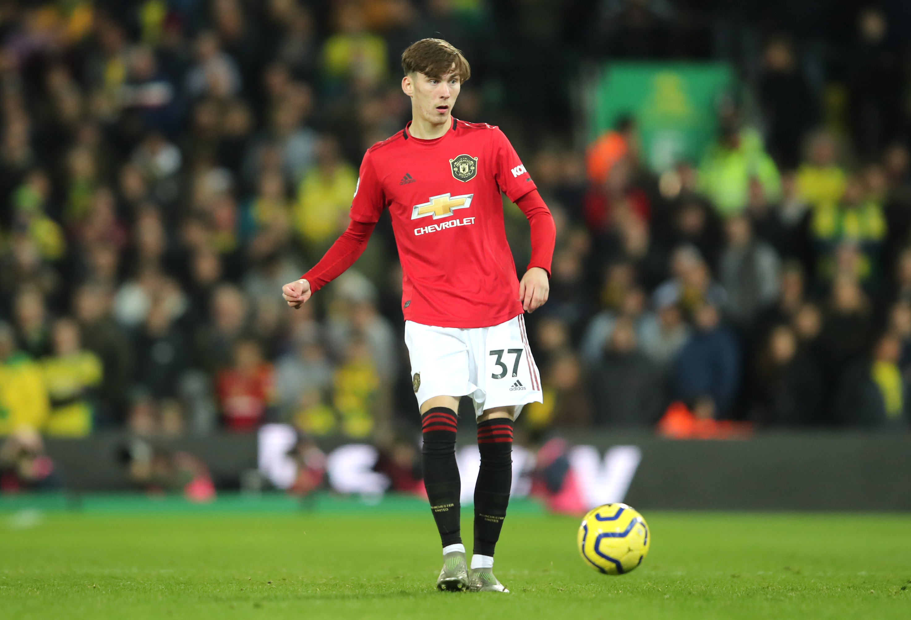 James Garner plays the ball while in action for Man United against Norwich.