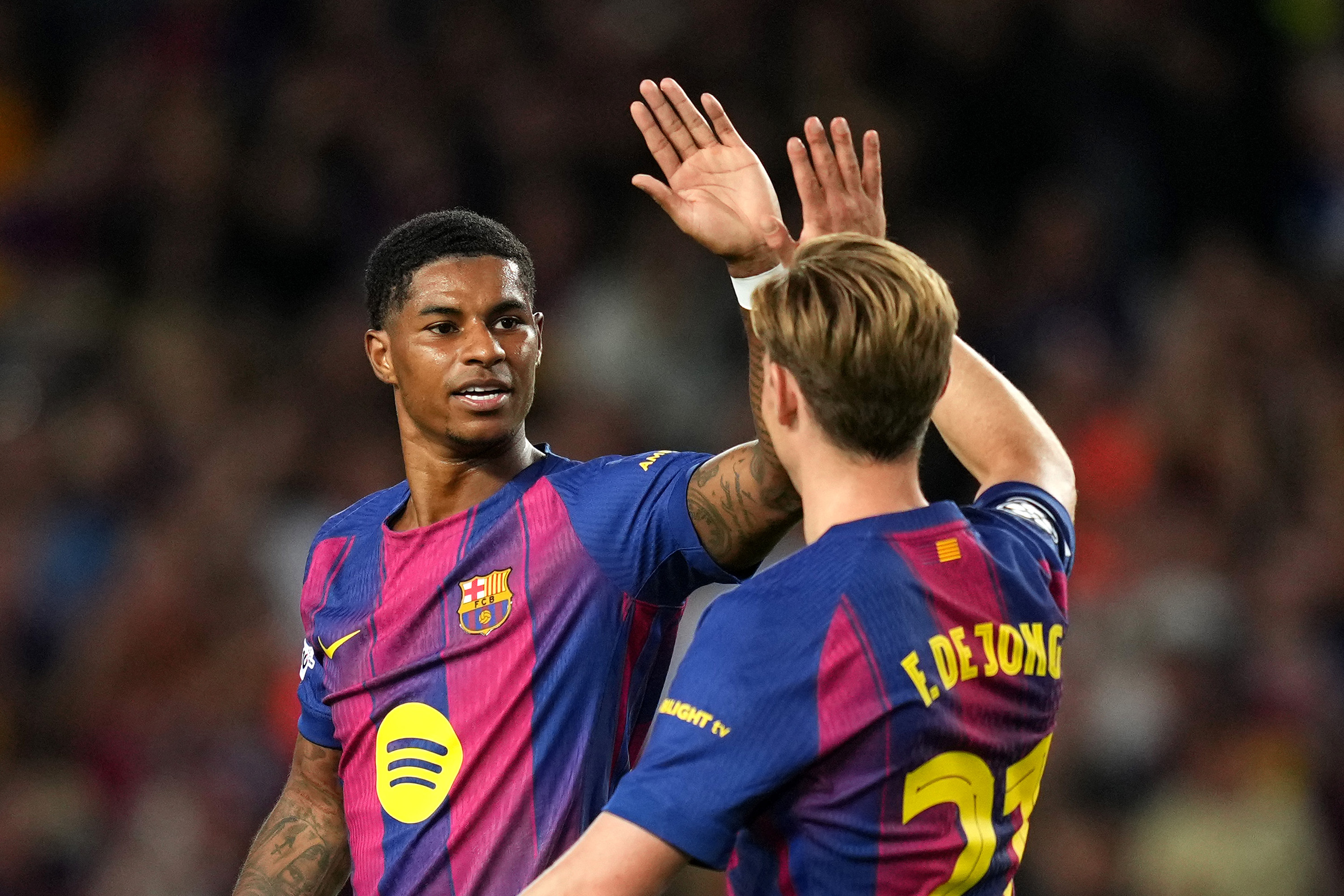 Marcus Rashford high-fives Frenkie de Jong after scoring for Barcelona.