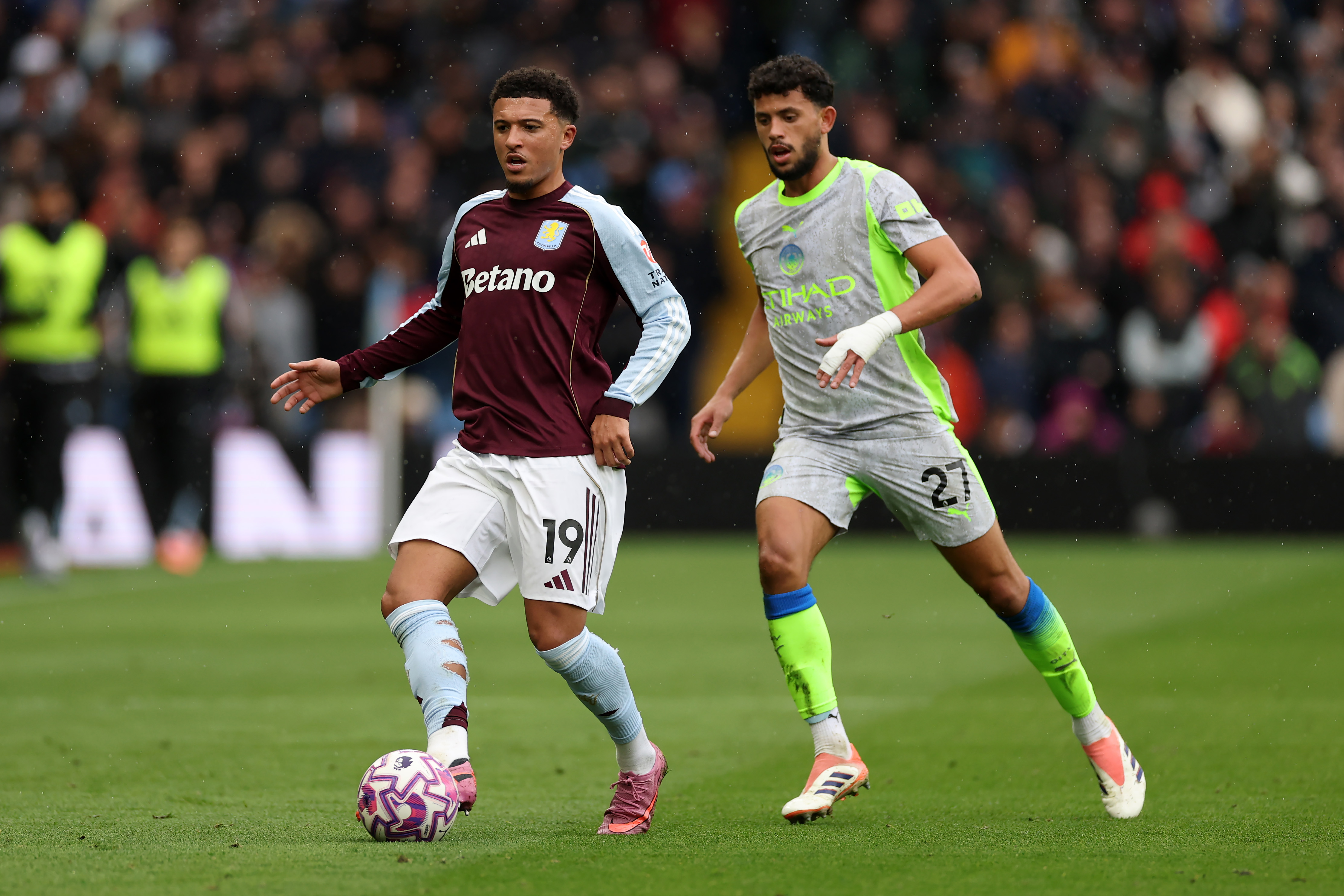Jadon Sancho plays the ball while under pressure from Matheus Nunes.