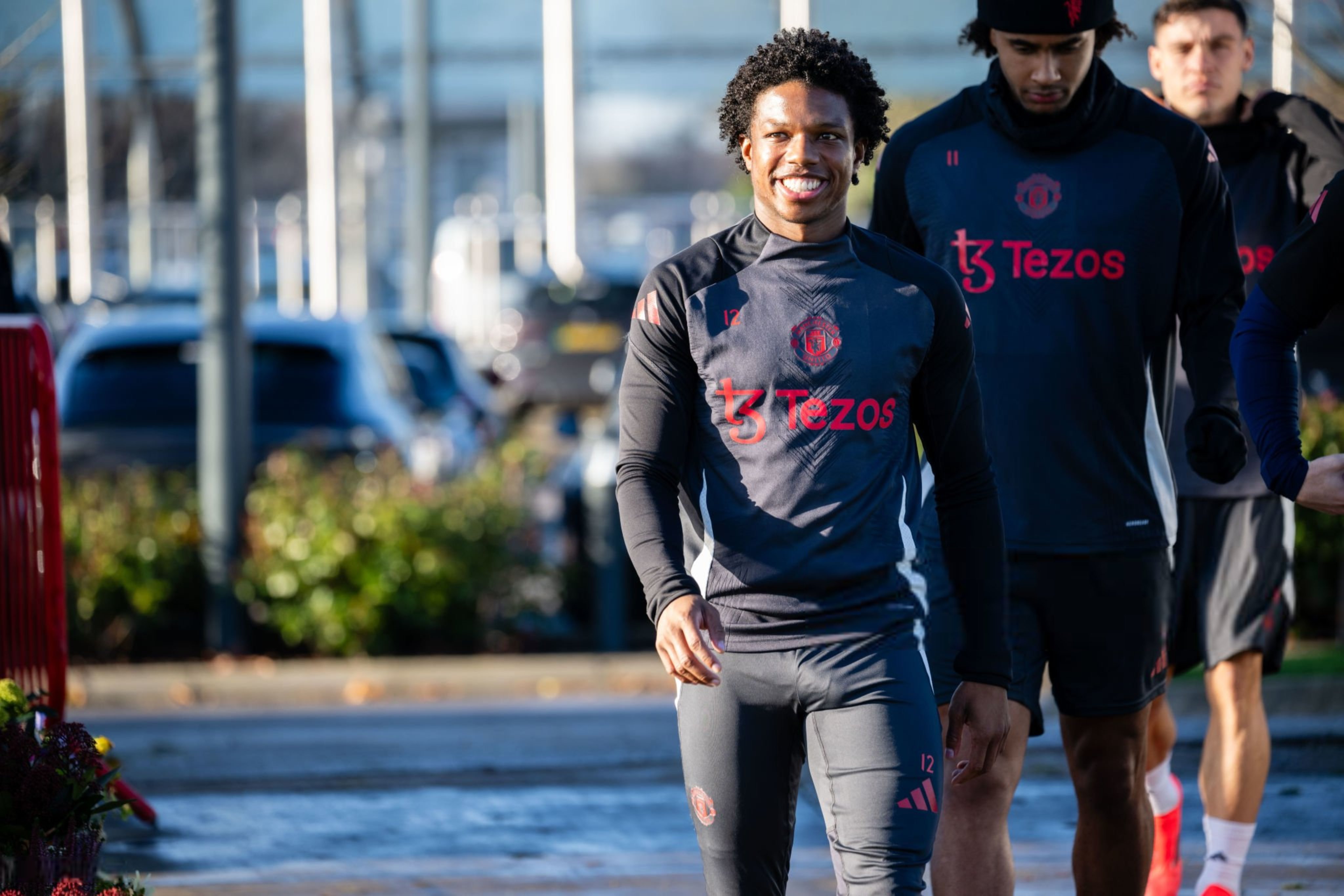Tyrell Malacia smiles at Carrington.