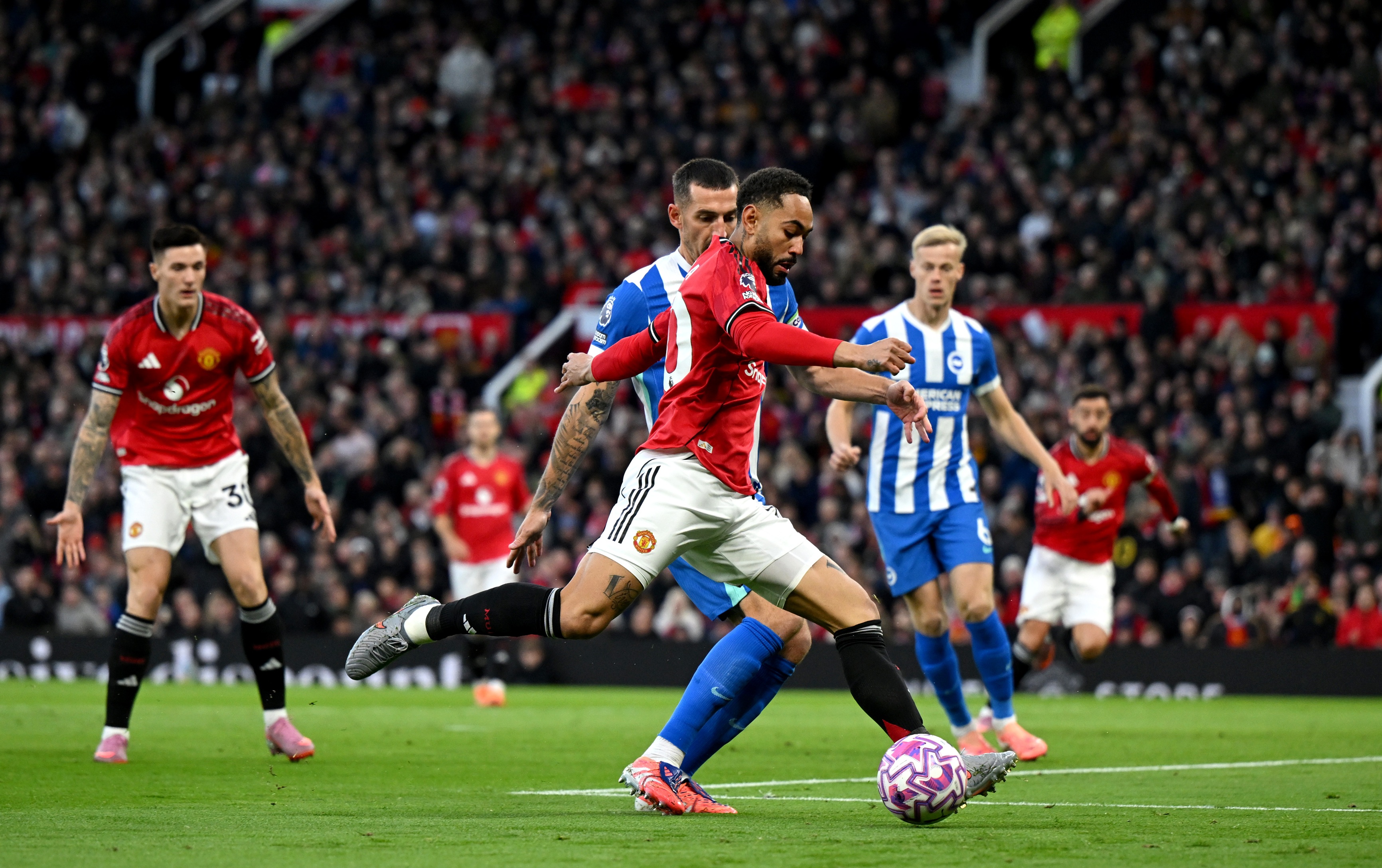 Matheus Cunha lifts his leg to shoot the ball against Brighton.