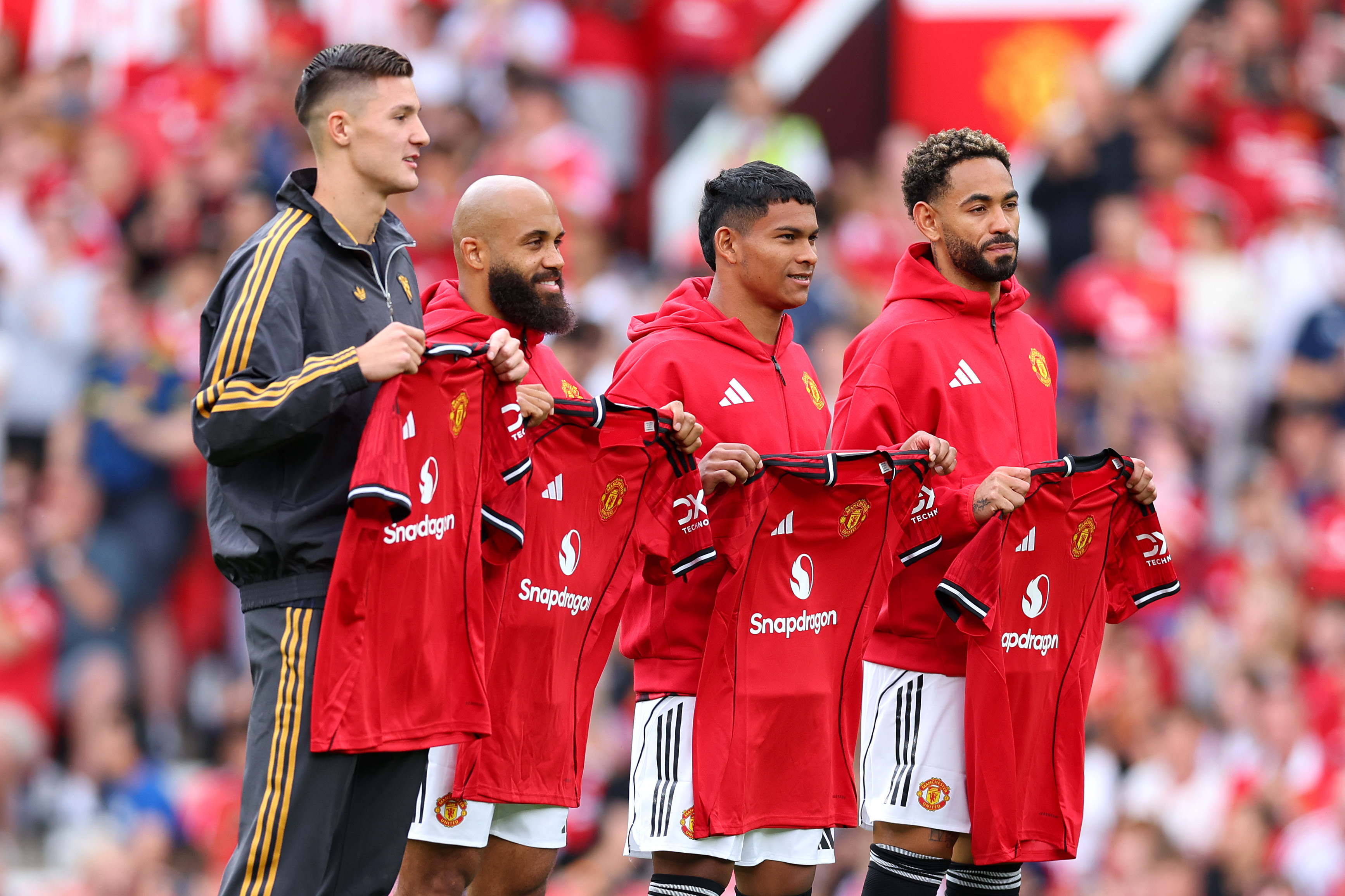 Man United’s summer signings pose with their shirts at Old Trafford.
