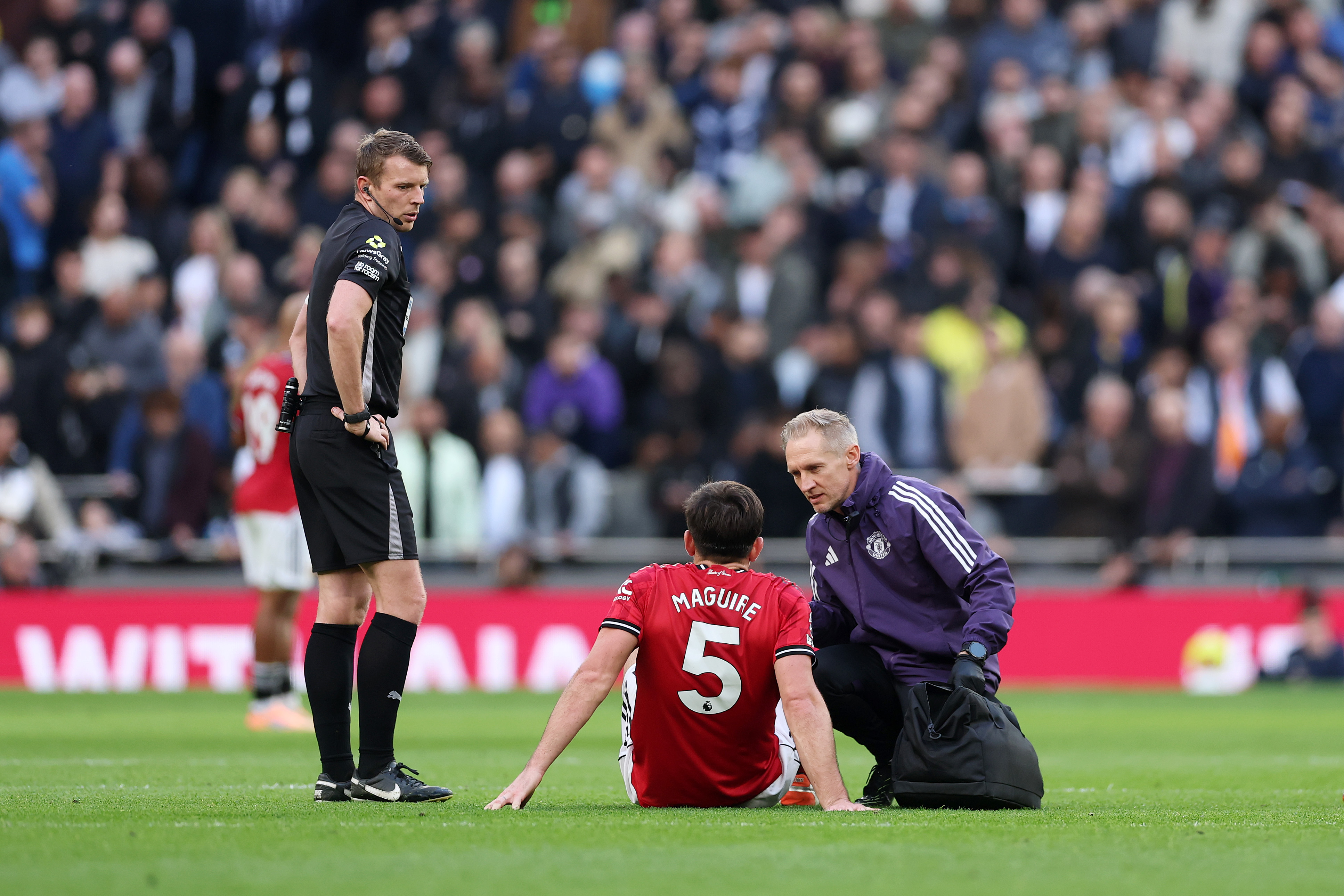 Harry Maguire receives treatment from a Man United physio.