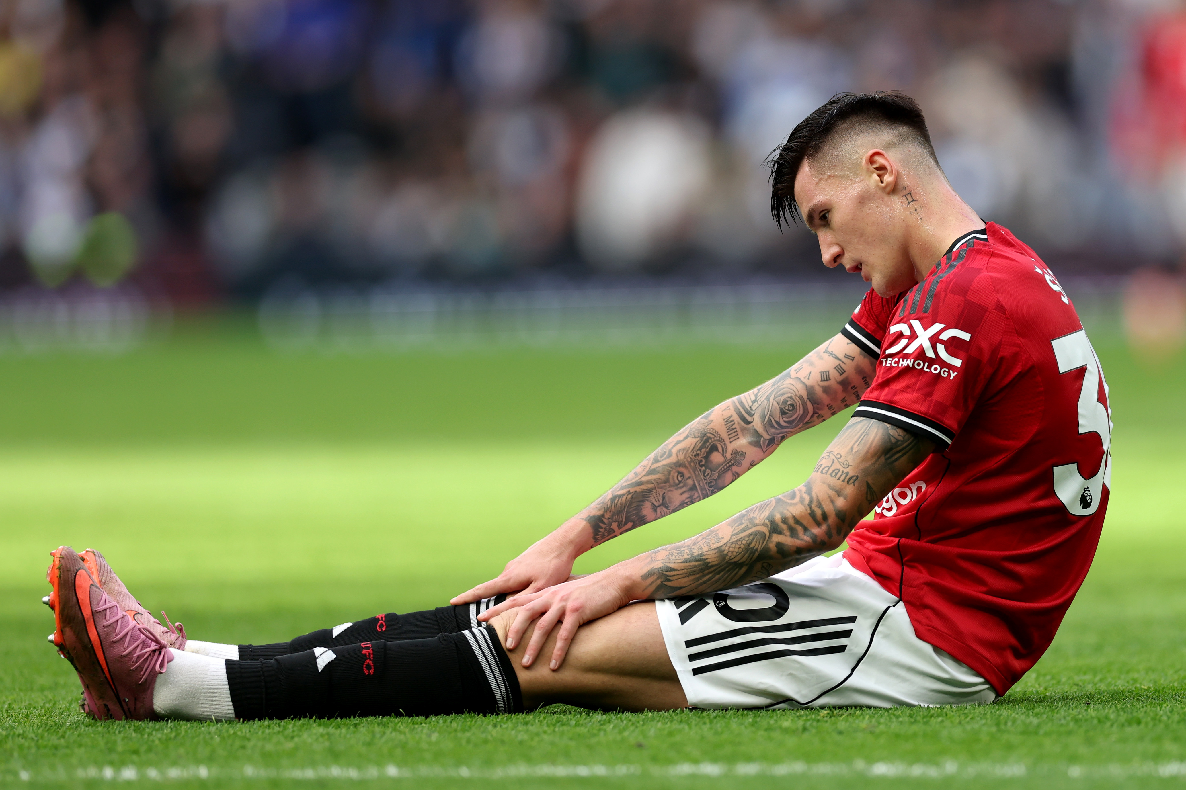 Benjamin Sesko sits on the floor after sustaining an injury vs Tottenham.