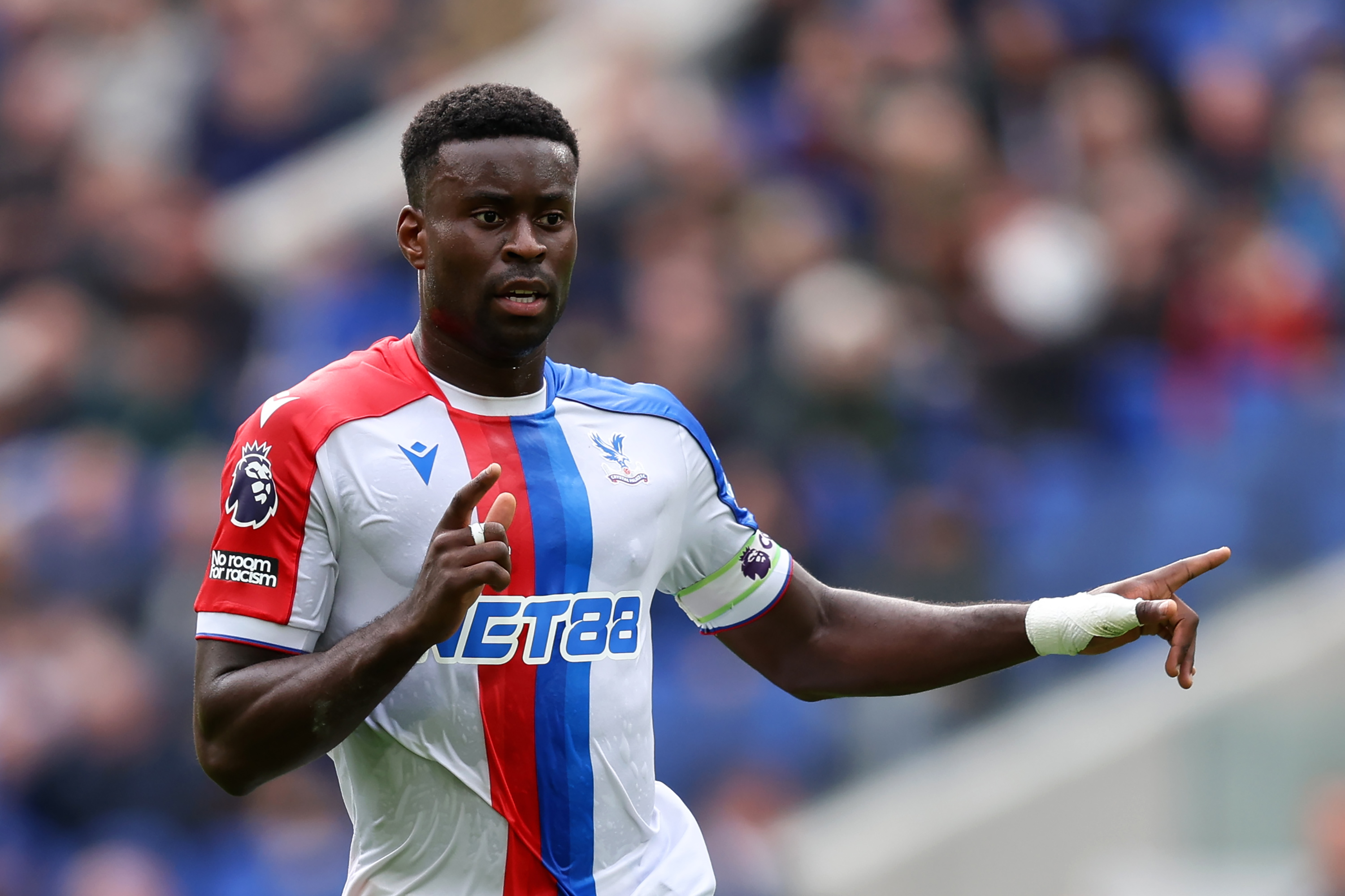 Marc Guehi gestures while in action for Crystal Palace.
