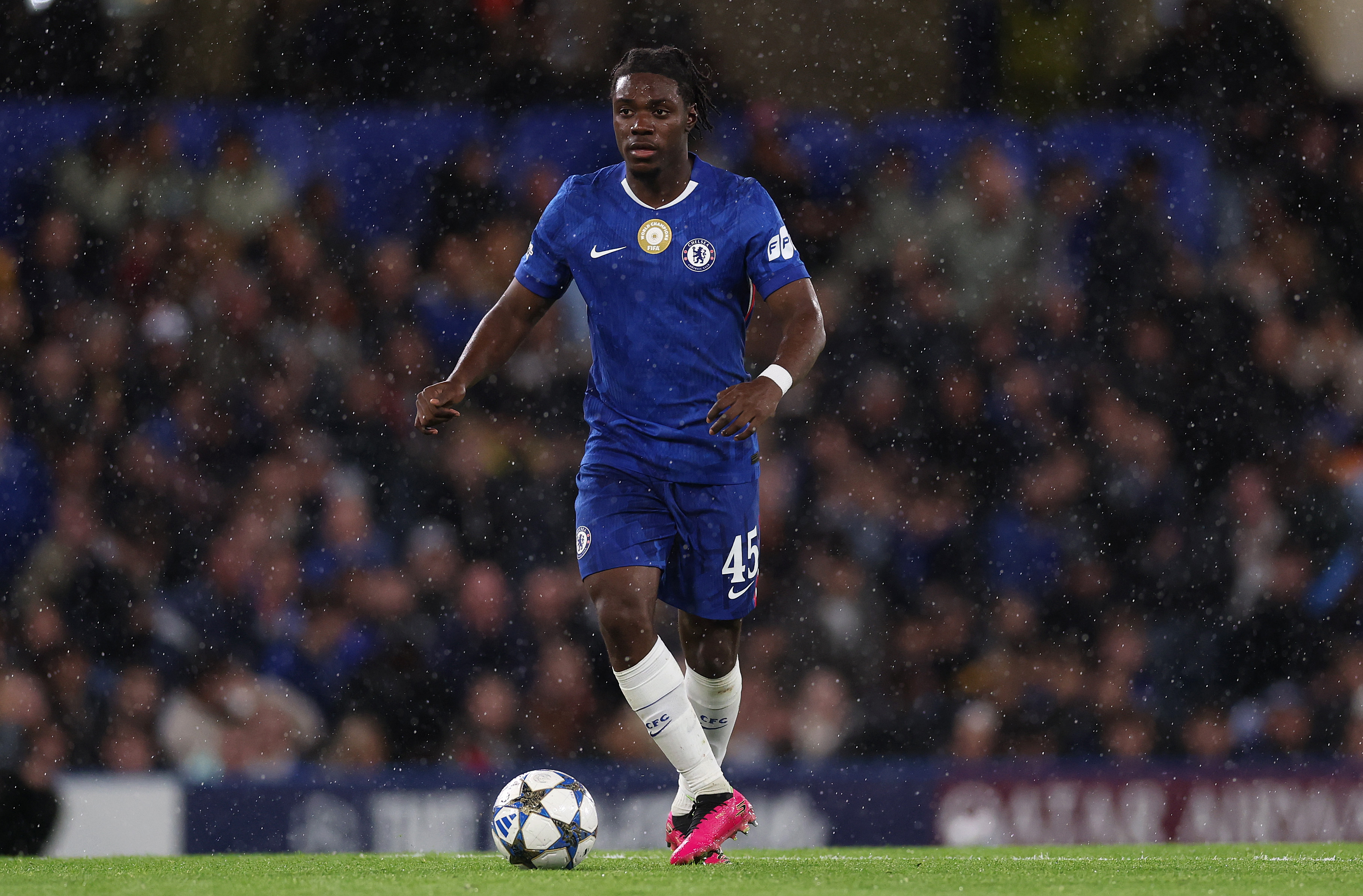 Romeo Lavia carries the ball while in action for Chelsea against Ajax.