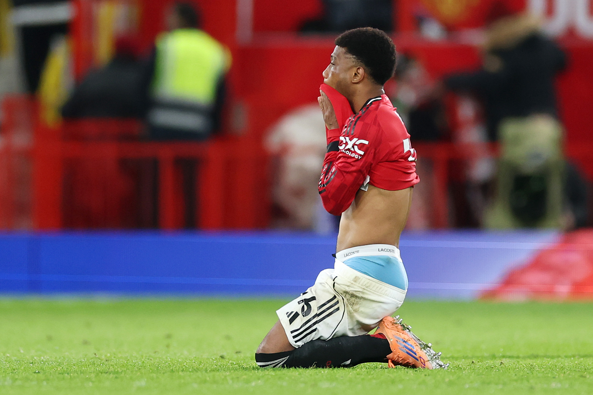 Amad Diallo drops to his knees after Man United lose to Everton at Old Trafford.