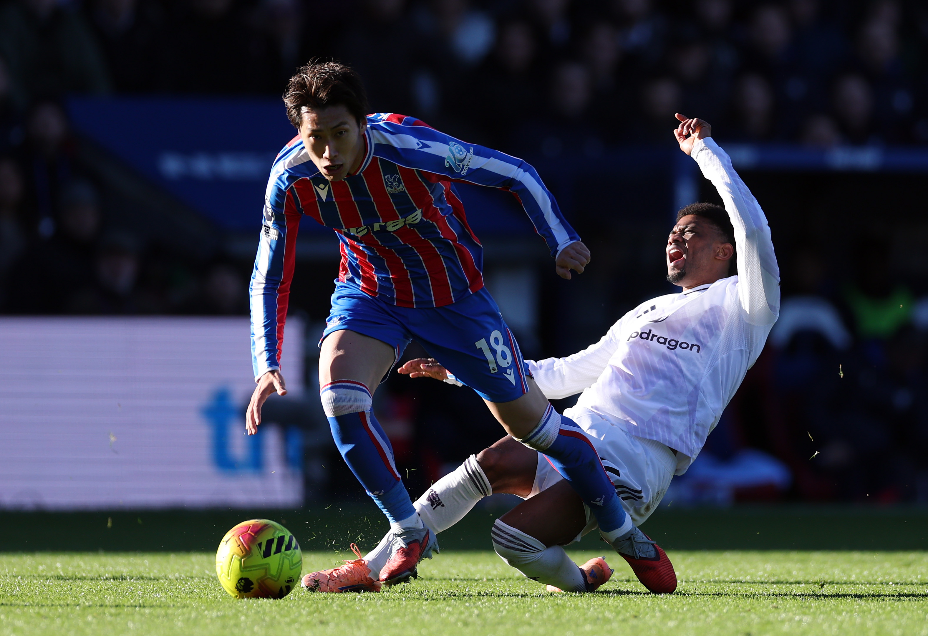 Daichi Kamada of Crystal Palace is challenged by Amad Diallo of Manchester United during the Premier League match between Crystal Palace and Manchester United at Selhurst Park on November 30, 2025 in London, England.
