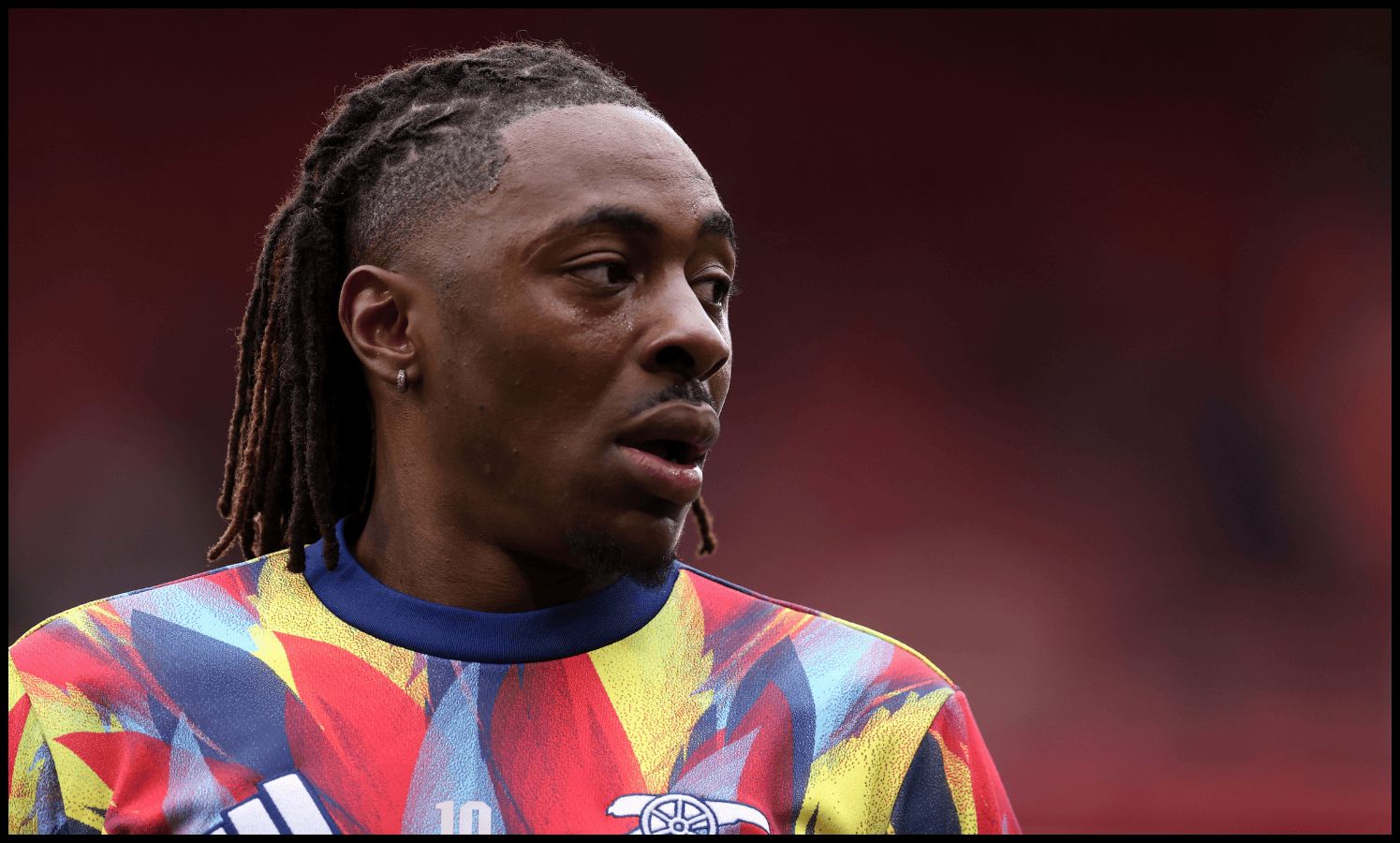 Eberechi Eze looks on while warming up for Arsenal.
