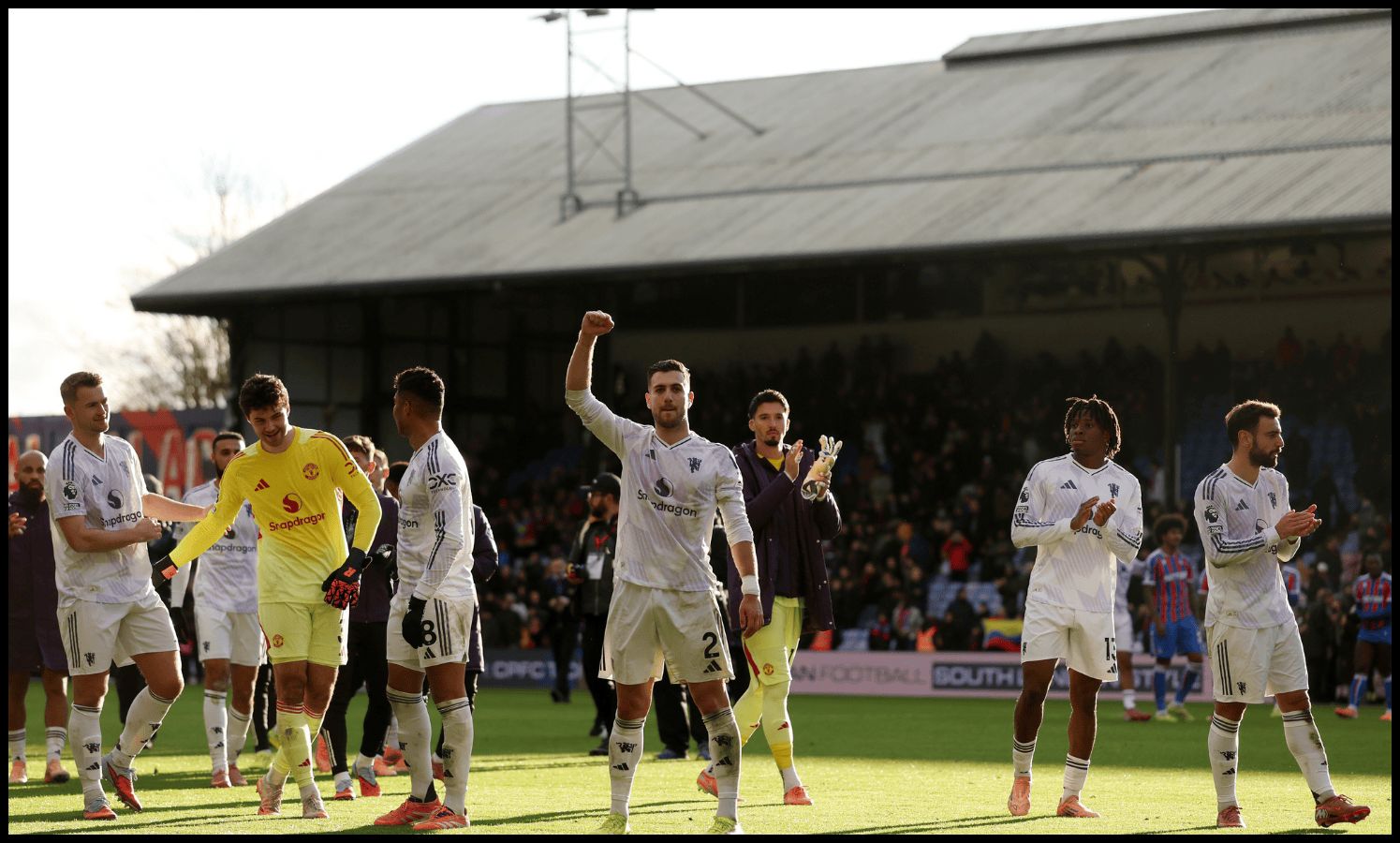 Man United players celebrate with their fans at full-time.