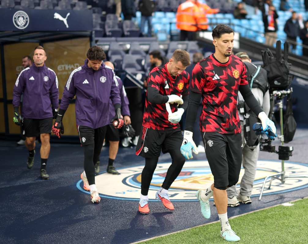 Altay Bayindir, Tom Heaton and Senne Lammens walk out to start their warm ups at the Etihad.