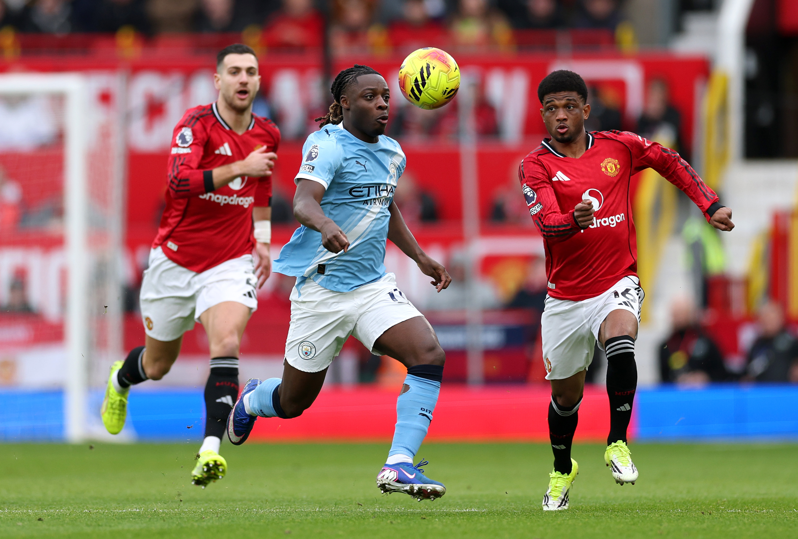 Amad Diallo vies with Jeremy Doku while in action for Man United vs Man City.