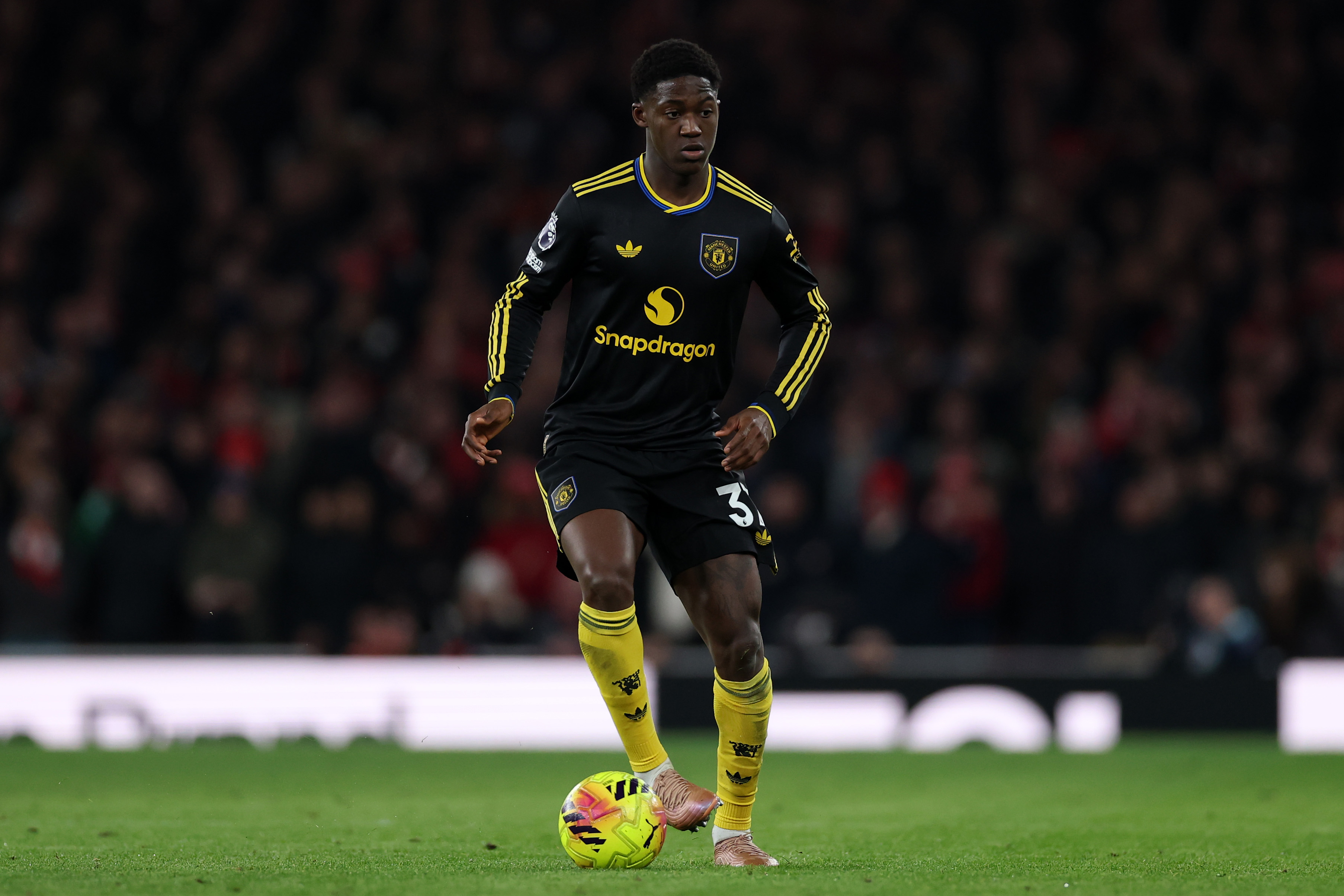 Kobbie Mainoo controls the ball while in action vs Arsenal.