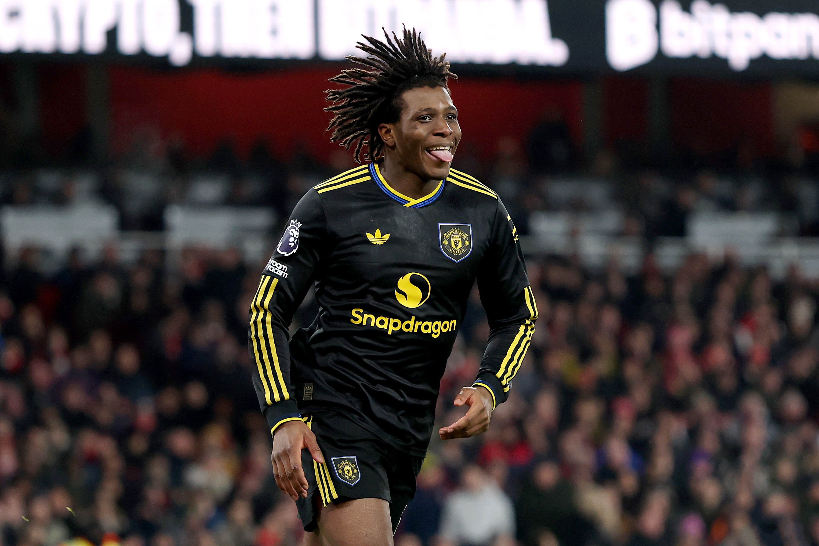 Patrick Dorgu sticks his tongue out in celebration during Manchester United game.