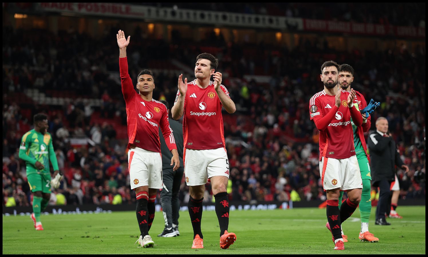 Harry Maguire and Casemiro saluting the fans