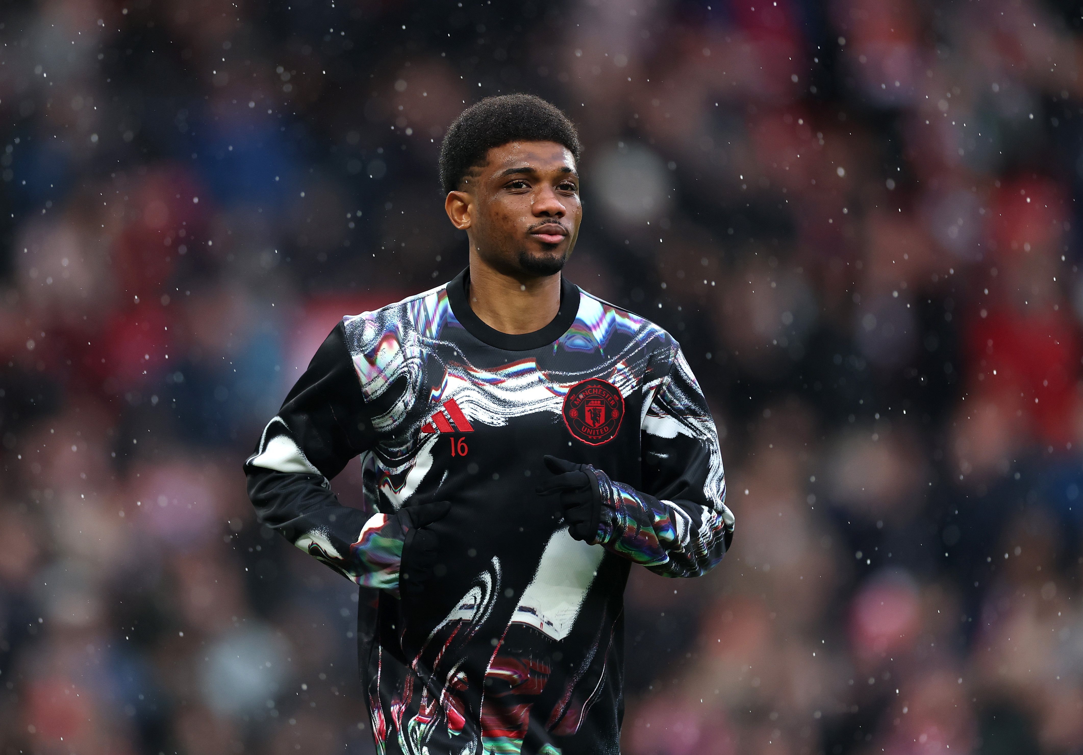 Amad Diallo warms up at Old Trafford before kick-off