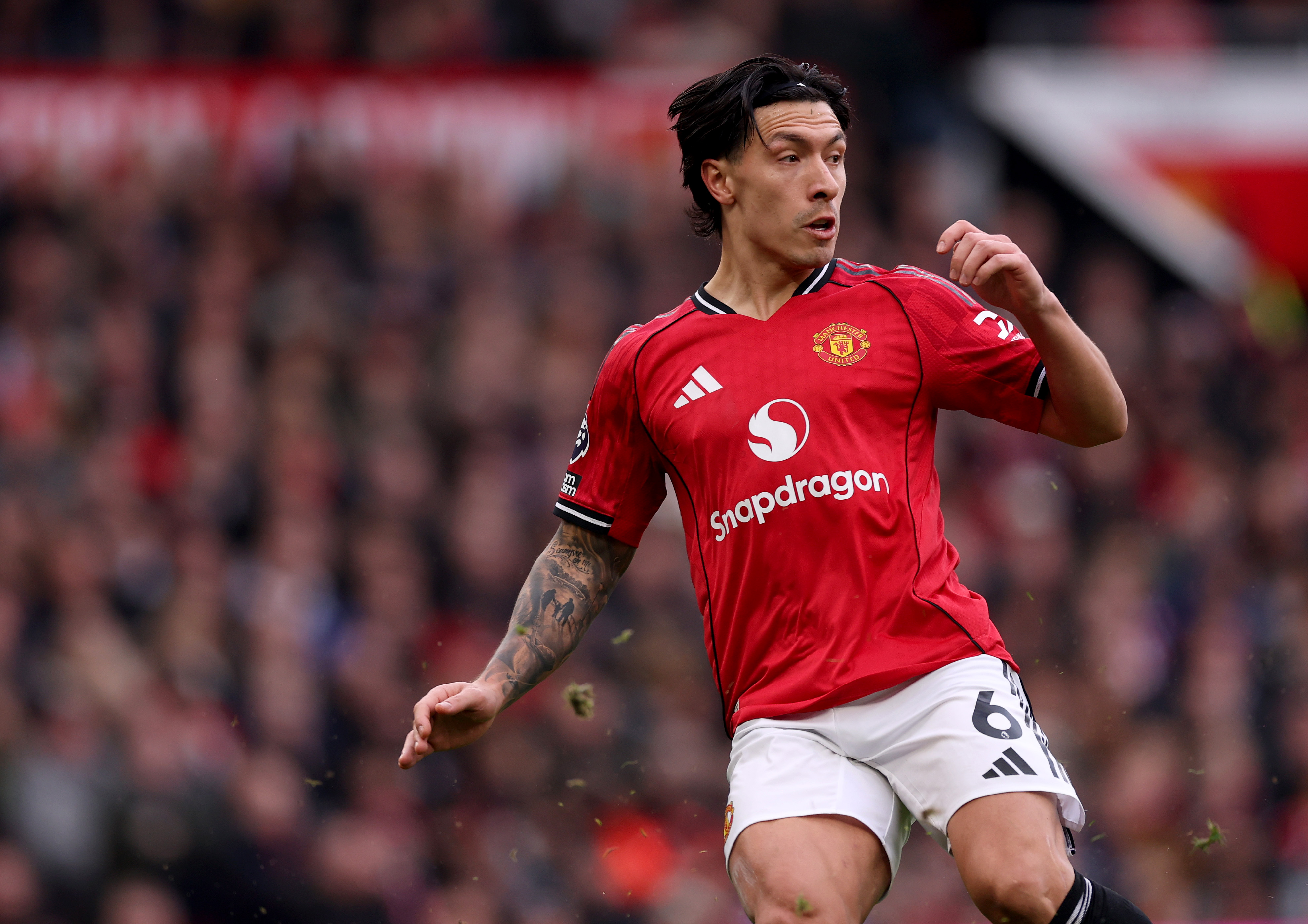Lisandro Martinez plays the ball while in action vs Fulham.