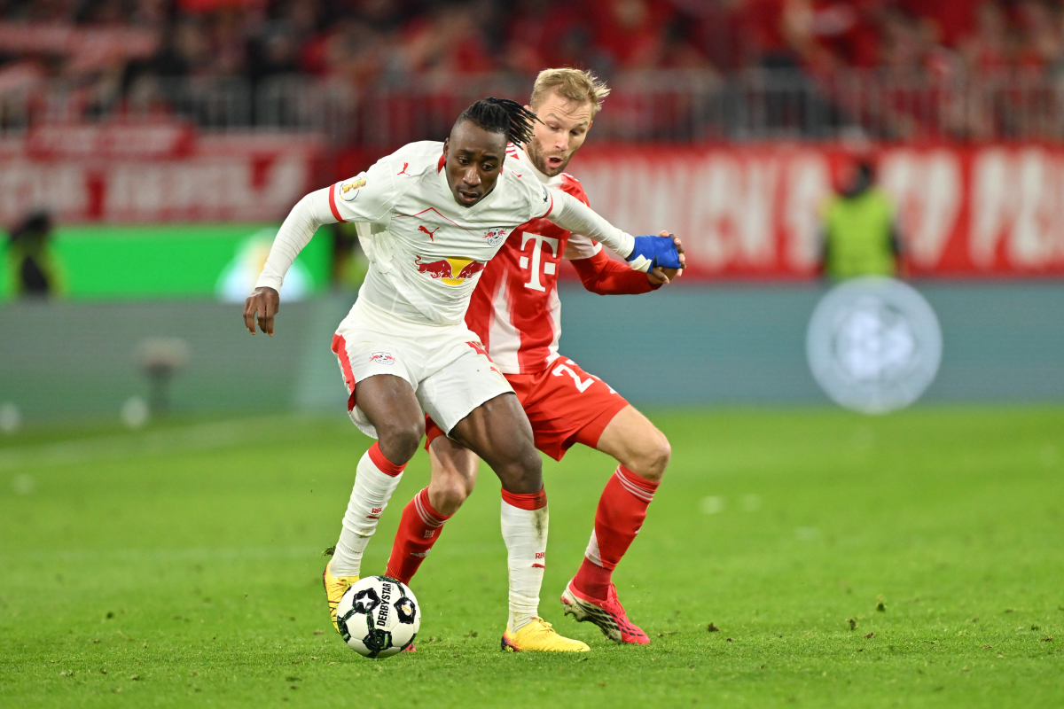 MUNICH, GERMANY - FEBRUARY 11: Yan Diomande of RB Leipzig and Konrad Laimer of FC Bayern Munich compete for the ball during the DFB Cup Quarter Final match between FC Bayern Munich and RB Leipzig at Allianz Arena on February 11, 2026 in Munich, Germany.