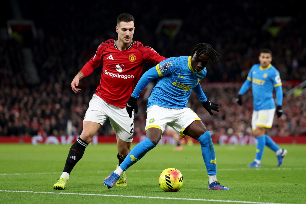 Wolves’ Mateus Mane shields the ball from Man United’s Diogo Dalot. 