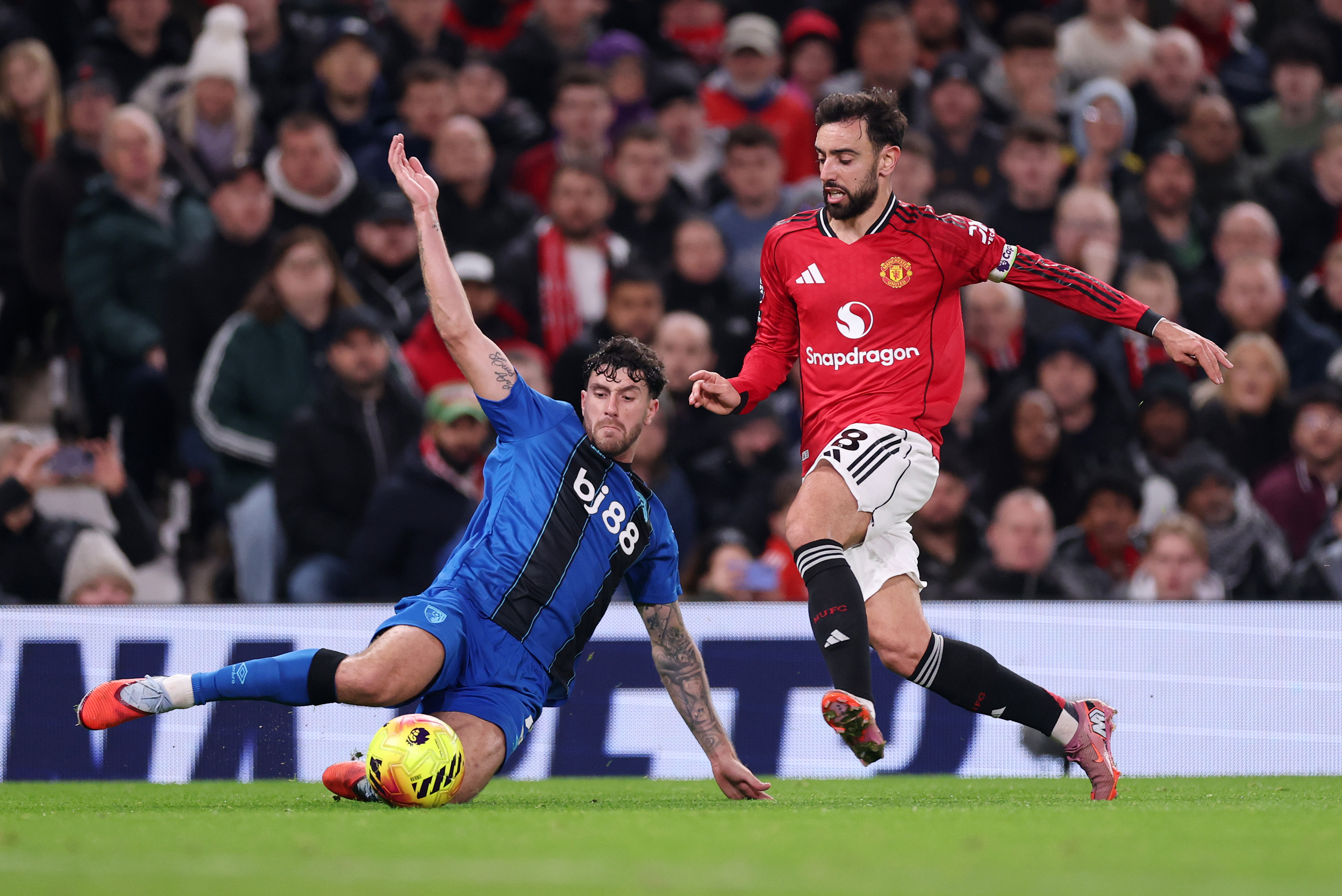 Marcos Senesi tackling Bruno Fernandes