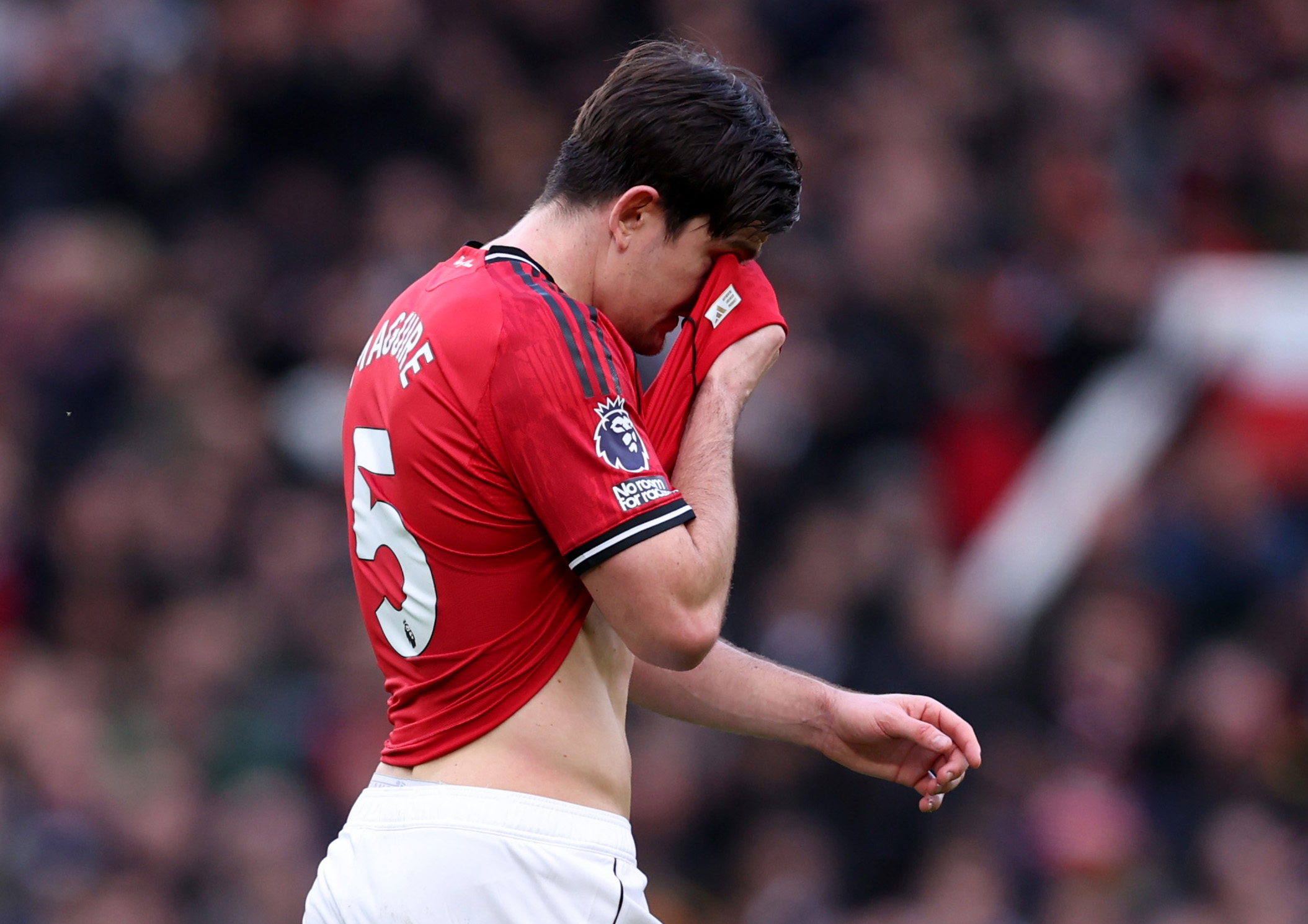 Harry Maguire lifts his shirt to his face after being substituted for Man United.