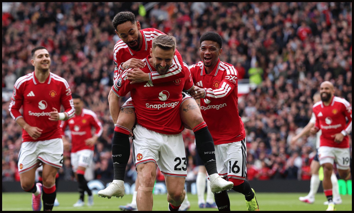 MANCHESTER, ENGLAND - MAY 17: Luke Shaw of Manchester United celebrates scoring his team's first goal with teammates Matheus Cunha and Amad Diallo during the Premier League match between Manchester United and Nottingham Forest at Old Trafford on May 17, 2026 in Manchester, England.