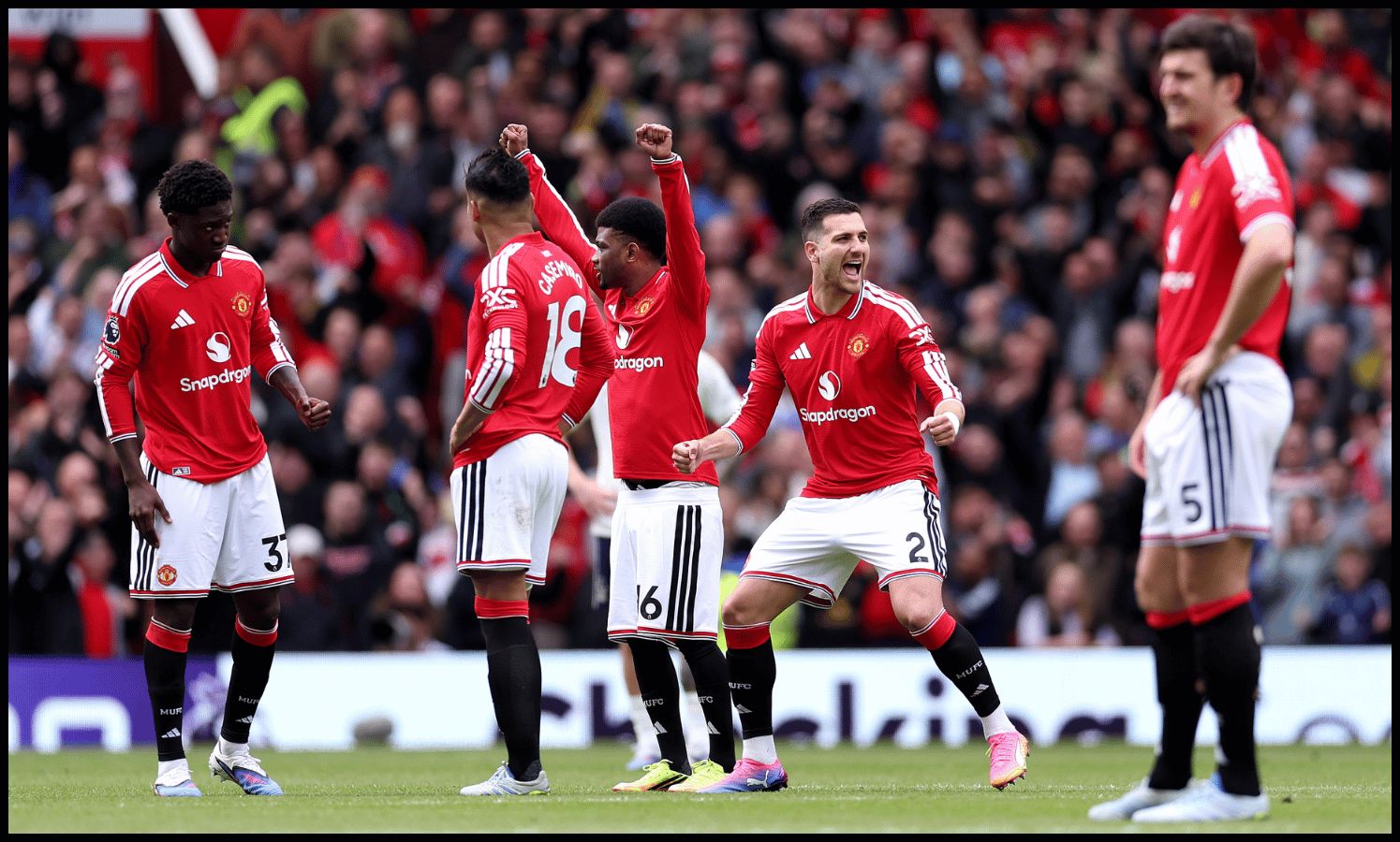 MANCHESTER, ENGLAND - MAY 17: Diogo Dalot of Manchester United and teammates celebrate after a VAR check confirms their second goal stands, scored by teammate Matheus Cunha (not pictured) during the Premier League match between Manchester United and Nottingham Forest at Old Trafford on May 17, 2026 in Manchester, England.