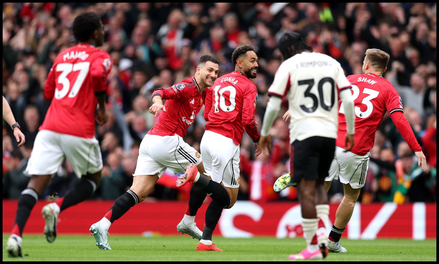 Matheus Cunha celebrating with Man Utd teammates
